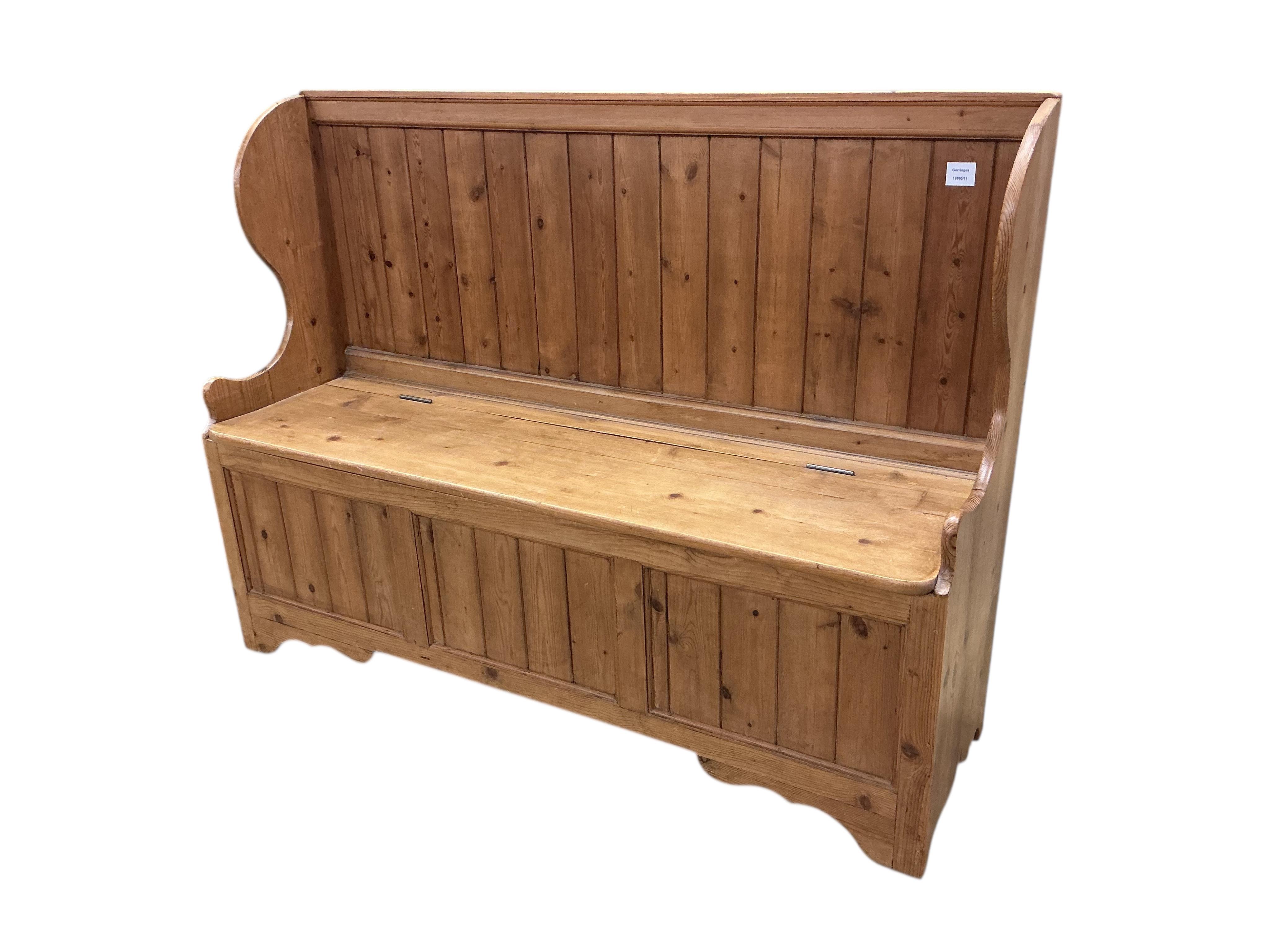 A Victorian style pine settle, with hinged box seat, width 135cm, depth 44cm, height 101cm